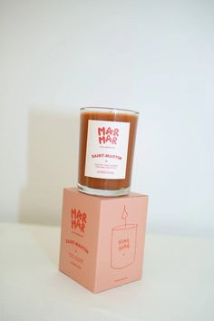 a candle sitting on top of a pink box that says mr and mrs har