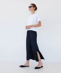 We continue to perfect our slip skirt. Once you slip on this insanely luxe silky charmeuse skirt, you'll realize that it's the sexiest companion you've ever seen to every tank top, knit top, sweater, blouse and button down you own (truly–this pairs with everything, it's like magic). It works with heels, sandals, loafers and even sneakers. It's possible that you may go through a phase where you wear nothing else. HERE FOR IT. Chic Silk Bottoms With Bias Cut, Chic Silk Bias Cut Bottoms, Relaxed Silk Skirt For Fall, Stretch Satin Bottoms For Summer, Summer Silk Bottoms With Bias Cut, Summer Silk Bias Cut Bottoms, Chic Silk Relaxed Skirt Bottoms, Summer Skirt With Side Slits For Night Out, Chic Silk Relaxed Skirt