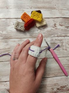 someone is crocheting together small pieces of yarn to make an ornament