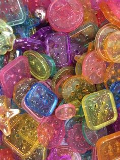 many different colored plastic objects with holes in the middle and small dots on them, as well as stars