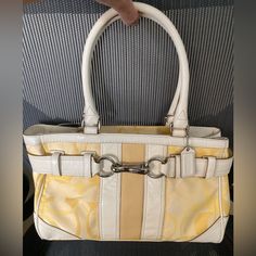 Brand New . Never Used. Original Price Tag Attached. Coated Canvas With Leather Trim. Zippers And Inside In New Condition. Color Is Light Yellow With Light Cream Leather Handles. No Discoloration (Just Shading While Taking Pictures). Will Ship In 1 Day Unless It’s A Weekend. Approx Dimensions- H = 8”, W = 12”, D =3 “ Yellow Shoulder Bag With Branded Hardware For Travel, Yellow Shoulder Bag With Branded Hardware, Elegant Yellow Coach Shoulder Bag, Yellow Coach Shoulder Bag With Gold-tone Hardware, Yellow Coach Satchel Shoulder Bag, Coach Yellow Shoulder Bag With Gold-tone Hardware, Coach Yellow Satchel Shoulder Bag, Yellow Coach Bag With Gold-tone Hardware, Coach Yellow Bag With Gold-tone Hardware