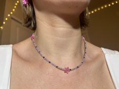 "dainty y2k-inspired necklace featuring pastel & black glass beads with acrylic pink holographic stars. two lobster clasps at the ends make it easy to close. this necklace is approximately 16.5\" in length and hits right around my collarbone." Trendy Pink Necklace With Star Charm, Pink Handmade Star Necklace, Handmade Pink Star Necklace, Pink Star-shaped Jewelry With Colorful Beads, Necklace Beads Ideas, Beads Necklace Ideas, Pink Beads Necklace, Y2k Beads, Pink Bead Necklace