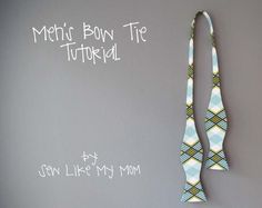 a tie hanging on the wall next to a chalkboard that says men's bow tie tutorial