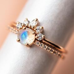 a close up of a ring with a rainbow stone in it on a napkin holder