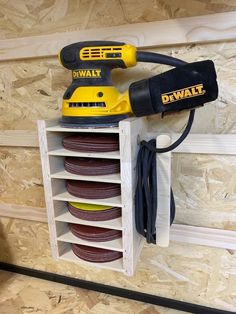 a drill and power tool on a wooden shelf