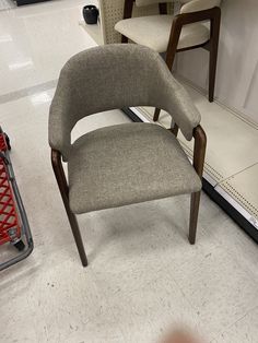 a chair sitting next to a shopping cart in a store