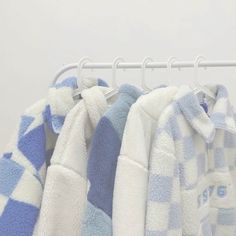 several blue and white towels hanging on a rack