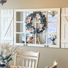 a dining room table and chairs with flowers in vases