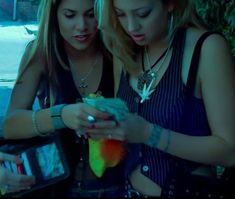 two young women looking at their cell phones