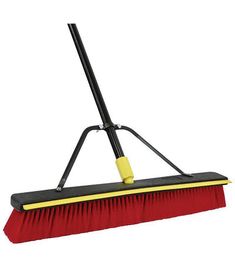 a red and black broom with yellow handle