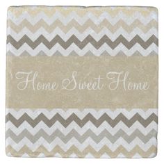 a stone coaster with the words home sweet home written on it in white and grey chevrons