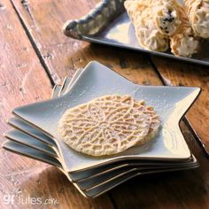 there is a plate with some cookies on it next to other plates and utensils