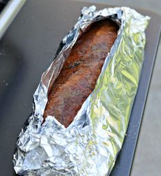 a piece of food that is sitting on some tin foil and it's ready to be eaten