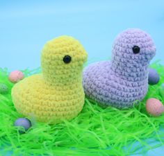 two crocheted ducks sitting in the grass