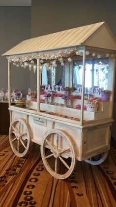 an old fashioned ice cream cart on display in a room with carpeted flooring