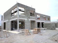 a house under construction with scaffolding on the front and side walls in progress