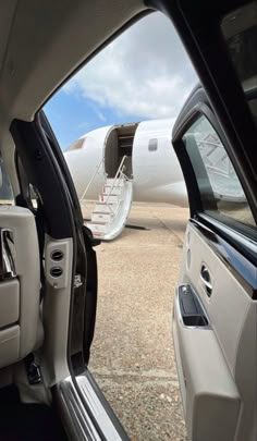 an airplane is parked on the tarmac with it's door open and another plane in the background