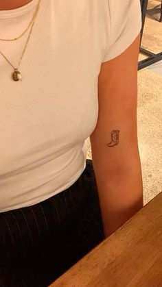 a woman with a small tattoo on her arm