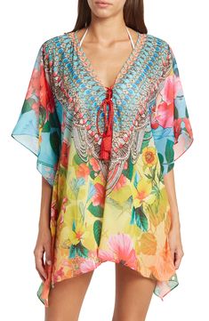 A breezy and lightweight poncho in a blooming floral print brings effortless boho vibes to your wardrobe. 31'' length (O/S) V-neck with lace-up closure Kimono sleeves All-over print Woven 100% polyester Dry clean Imported Model stats: 5'10", 32" bust, 25" waist, 36" hip. Model is wearing size OS. Bohemian V-neck Kaftan For Spring, Vacation V-neck Kaftan With Tassel Ties, V-neck Floral Print Festival Cover-up, Multicolor Poncho For Beach Cover-up In Summer, Bohemian V-neck Cover-up With Floral Print, Bohemian V-neck Floral Print Cover-up, Spring Bohemian Poncho With Kimono Sleeves, Spring Floral Print V-neck Kaftan, Bohemian Floral Print Kaftan For Beach Season