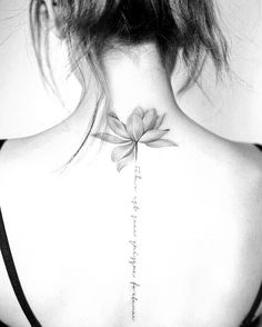 the back of a woman's neck with a flower on it