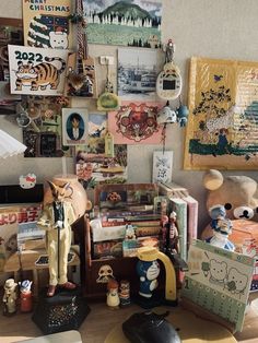 there are many items on the table in this room, including toys and pictures hanging on the wall