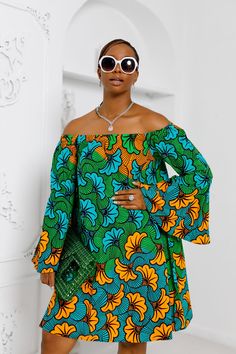 This stylish off-shoulder dress is the perfect addition to your wardrobe. Featuring a bell sleeve and side pockets, this dress is sure to make a statement. The flexible design and comfortable fabric ensure you’ll look and feel your best all day. FEATURES.* 100% African Wax Cotton* Bell Sleeve style* Off shoulder neckline* Side pockets and Dress is Unlined* Dress is 40’’ long for size S/M* Model Is Wearing A Size S/M and 2XL/3XLCARE INSTRUCTION* Hand Wash in Cold Water.* Do Not Bleach.* Press with Cool Iron on The Wrong Side African Chic, Big Girl Dresses, Ankara Short Gown Styles, African Print Dress Ankara, African Clothes, African Fashion Modern, Short Gowns, African Print Fashion, Flexible Design