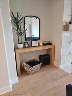 a living room with a fireplace and mirror on the wall