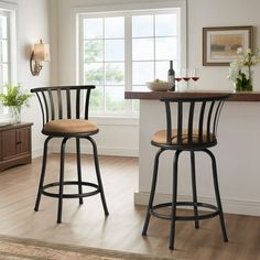 two black barstools sitting in front of a window