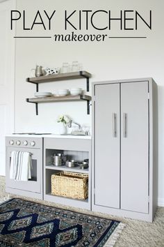 a white kitchen with an oven, sink and rug on the floor in front of it