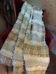 a pile of blankets sitting on top of a red chair