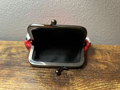 a small purse sitting on top of a wooden table