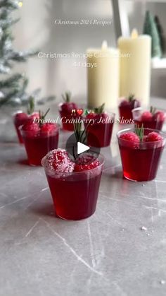 christmas recipe cranberry jello shots on the table with candles in the background