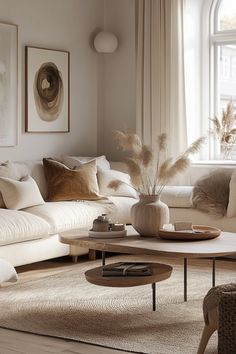 a living room filled with lots of furniture next to a large white couch and coffee table