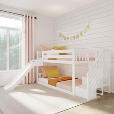 a white bunk bed with a slide and pillows