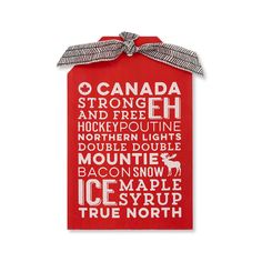 a red gift bag with the words canada printed on it and a bow around the neck