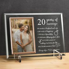 an anniversary photo frame with a couple's wedding date on the front and side