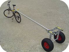 a bicycle is attached to a cart with wheels