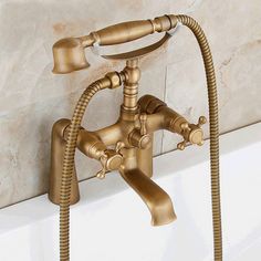 a faucet that is connected to a bathtub with hoses and handset