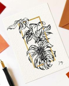 a card with flowers on it next to a pen and paper