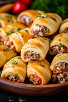 a plate filled with meat and cheese wrapped in crescent rolls