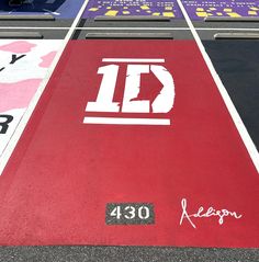 a parking lot has been painted with different colors and logos on it, including the letters id