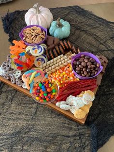 a tray filled with candy and snacks on top of a table