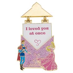 a pin with an image of a princess and prince on it, that says i loved you at once