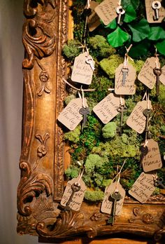 a wooden frame with moss and tags attached to it