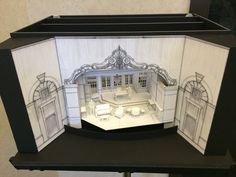 a cut out of a doll house with furniture