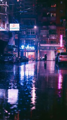 a city street at night in the rain