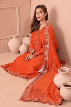 Orange kurta with thread embroidered floral jaal motifs and tukri work. Comes with palazzo and dupatta. - Aza Fashions Dabka Detailed Dola Silk Lawn Suit, Traditional Orange Designer Lawn Suit, Festive Orange Kurta With Floral Embroidery, Traditional Orange Lawn Suit For Designer Wear, Embroidered Orange Lawn Suit For Wedding, Eid Dola Silk Lawn Suit, Traditional Orange Palazzo Set With Dabka Work, Traditional Chinon Palazzo Set With Floral Embroidery, Eid Orange Kurta With Floral Embroidery