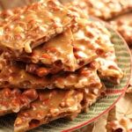 a stack of crackers sitting on top of a plate next to other pieces of food