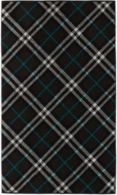 a black rug with blue and white plaid pattern on the bottom, in front of a white background