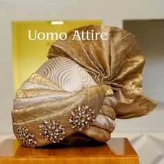 Get customized this this beautiful golden turban with broaches for best look at your big day. Exclusively available for #Customized orders at Uomo Attire. ☎️ For online orders and pricing inbox us OR Call/WhatsApp on +92300-7668666 / 0300-7618666 #PrinceCoat #menswear #style #fashion #sherwanidesign #groom #custom #bride #checksuit #latest #luxury #weddingsuit #beauty #studio #weddingdress #beautiful #jodhpuri #weddingday #weddingphotography #latestdesigns Broach For Men, Men Turban, Formal Menswear, Prince Coat, Suit Styles, Check Suit, Formal Mens Fashion, Groom Wear, Beauty Studio